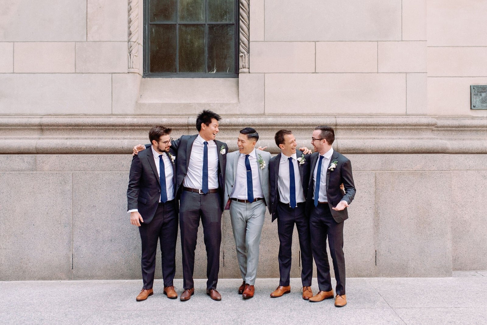 Candid moment Groom with his groomsmen toronto financial district downtown toronto wedding jacqueline james photography