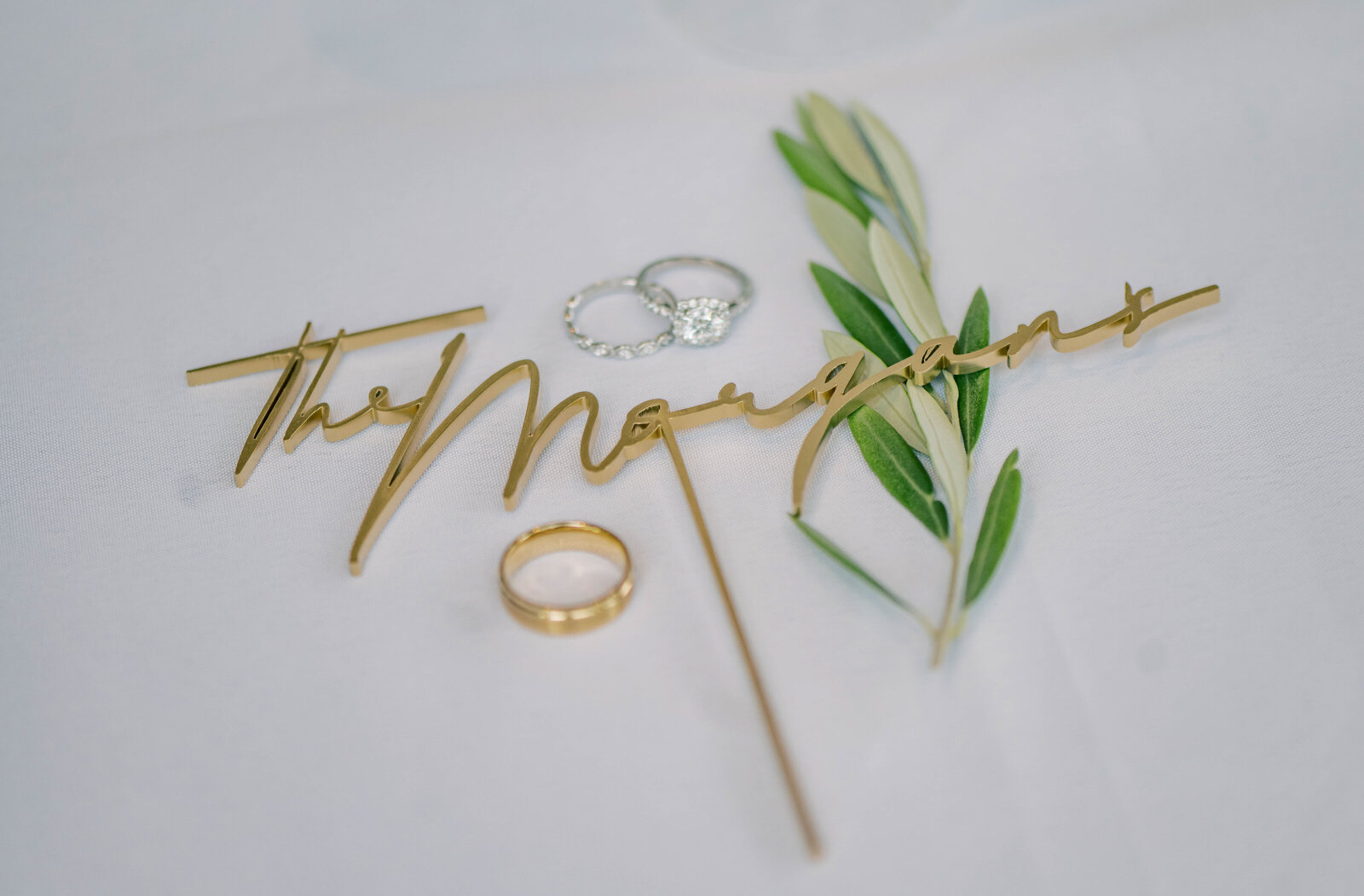gold cake topper with wedding rings by a Grand Rapids wedding photographer