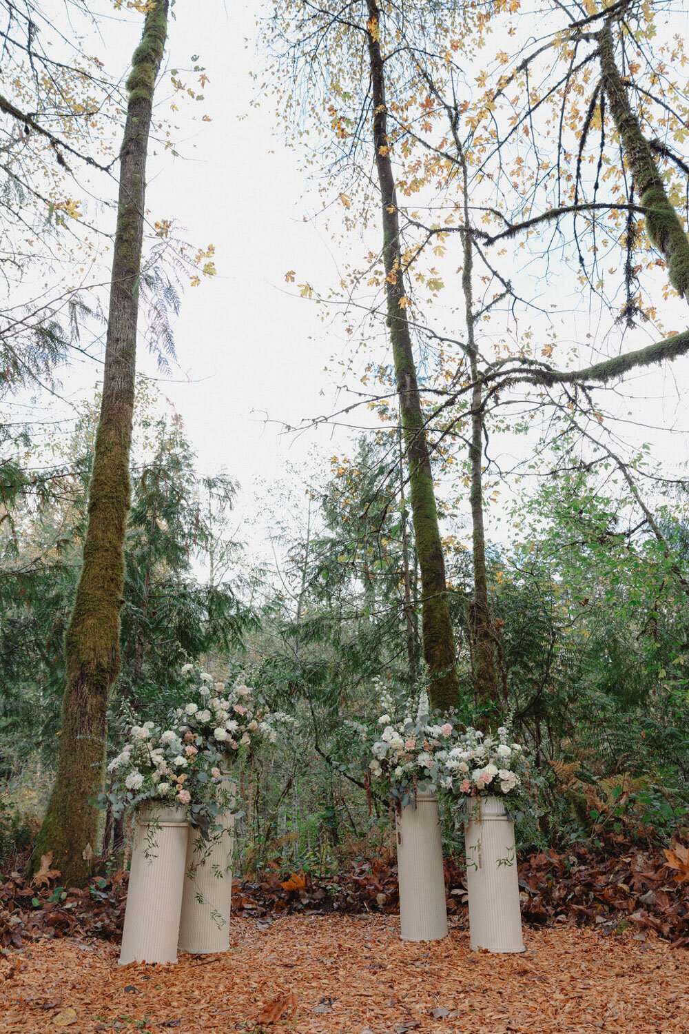 Outdoor wedding altar with floral arrangements in a forest setting