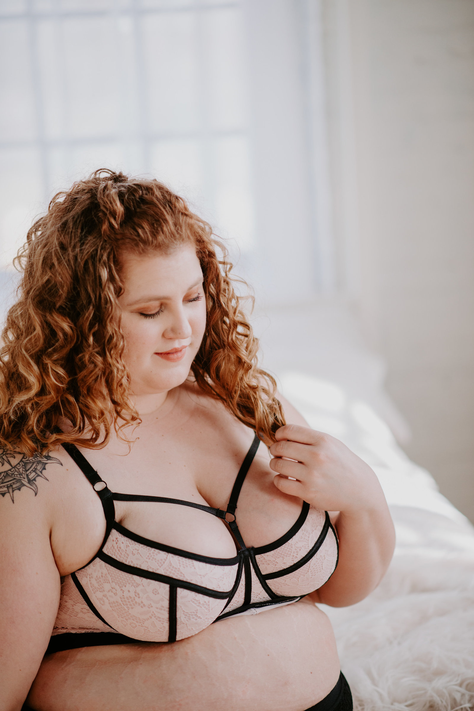plus size queer femme enjoying her self love boudoir session in Michigan