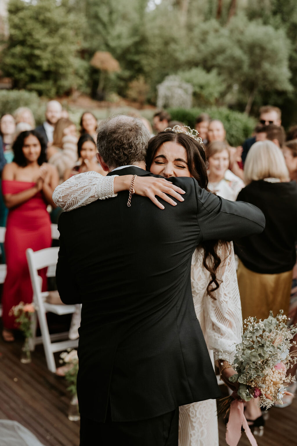 Bride hugging her dad at ceremony