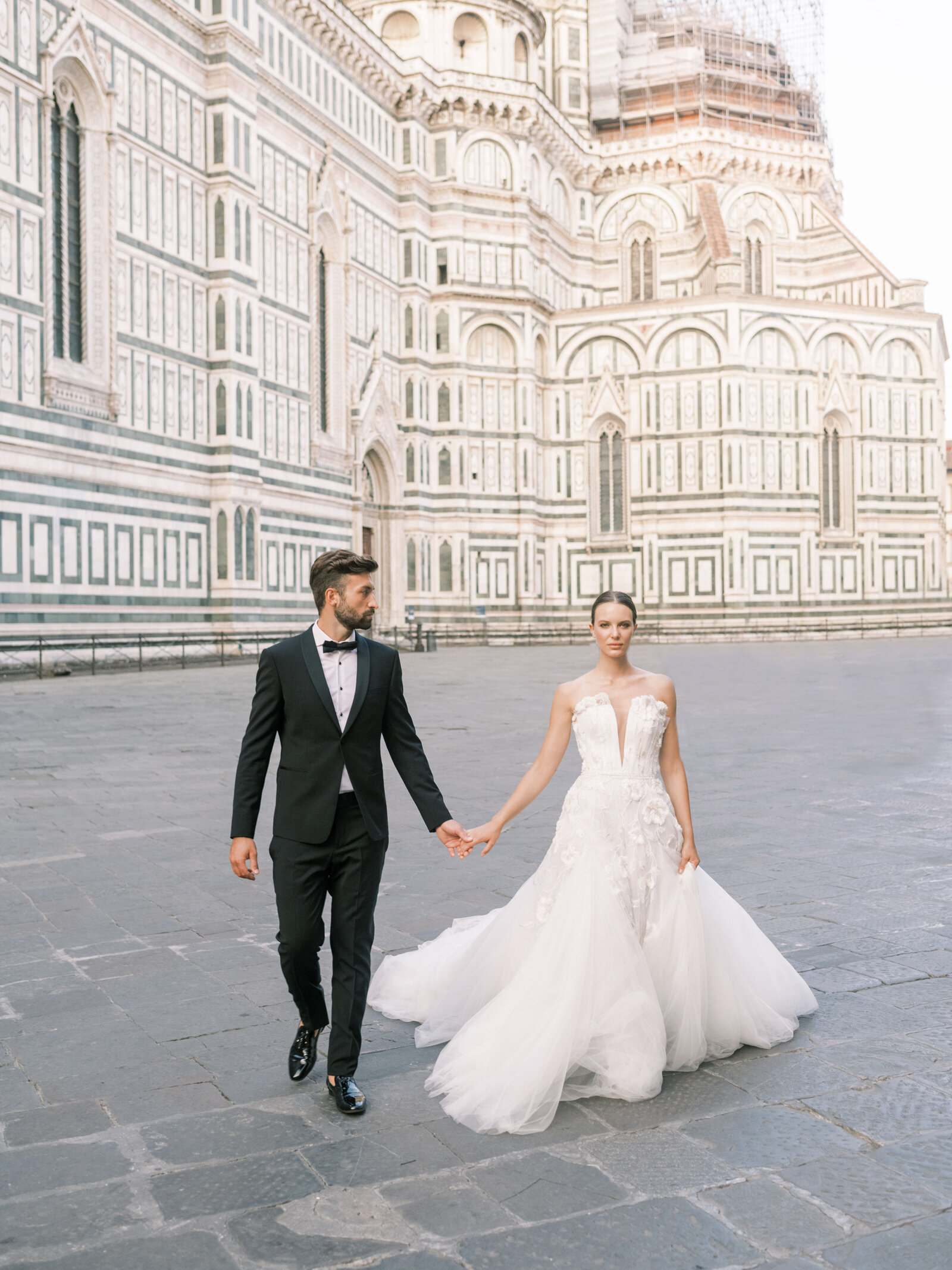 Bride and groom pose in front of Duomo in Florence Italy
