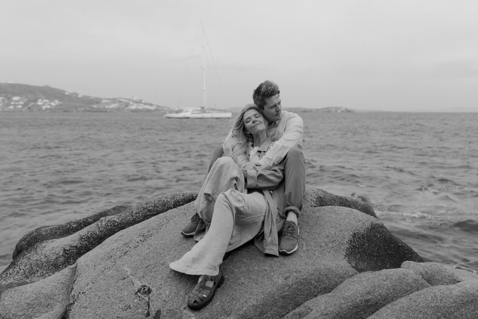 A couple hugging on the beach captured by an elopement photographer.