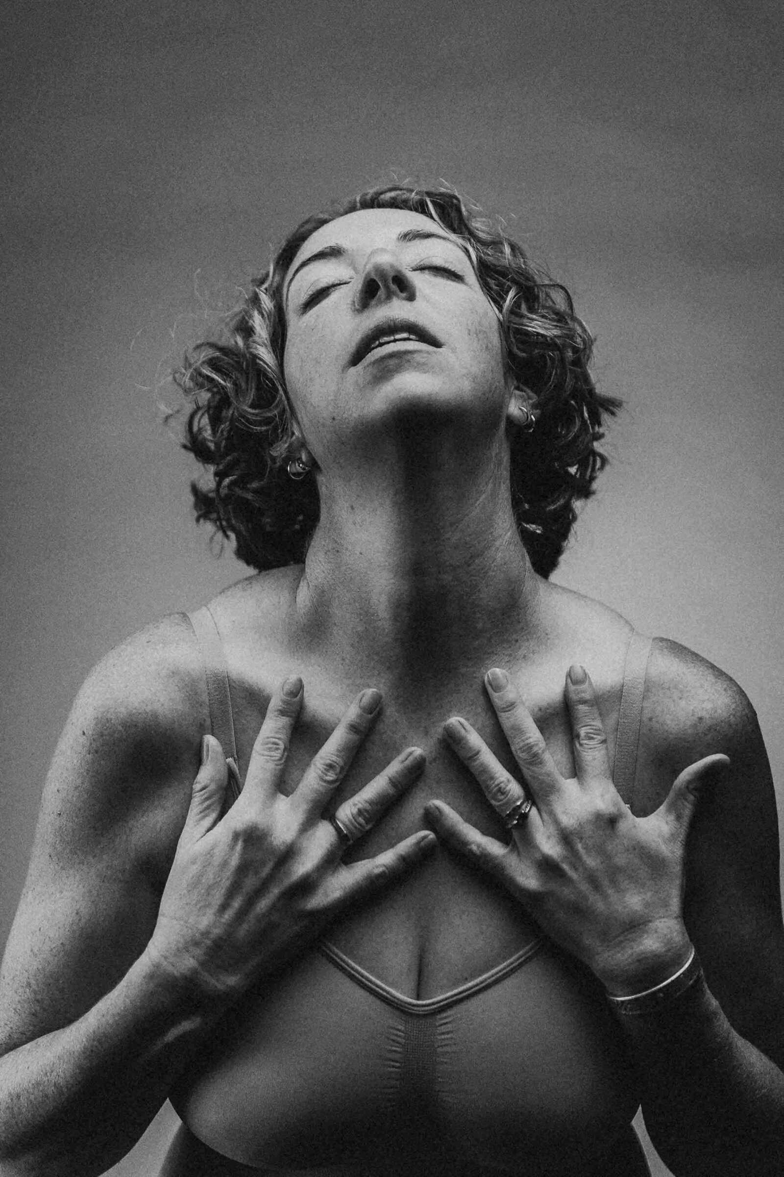 close up photo of a woman holding her chest