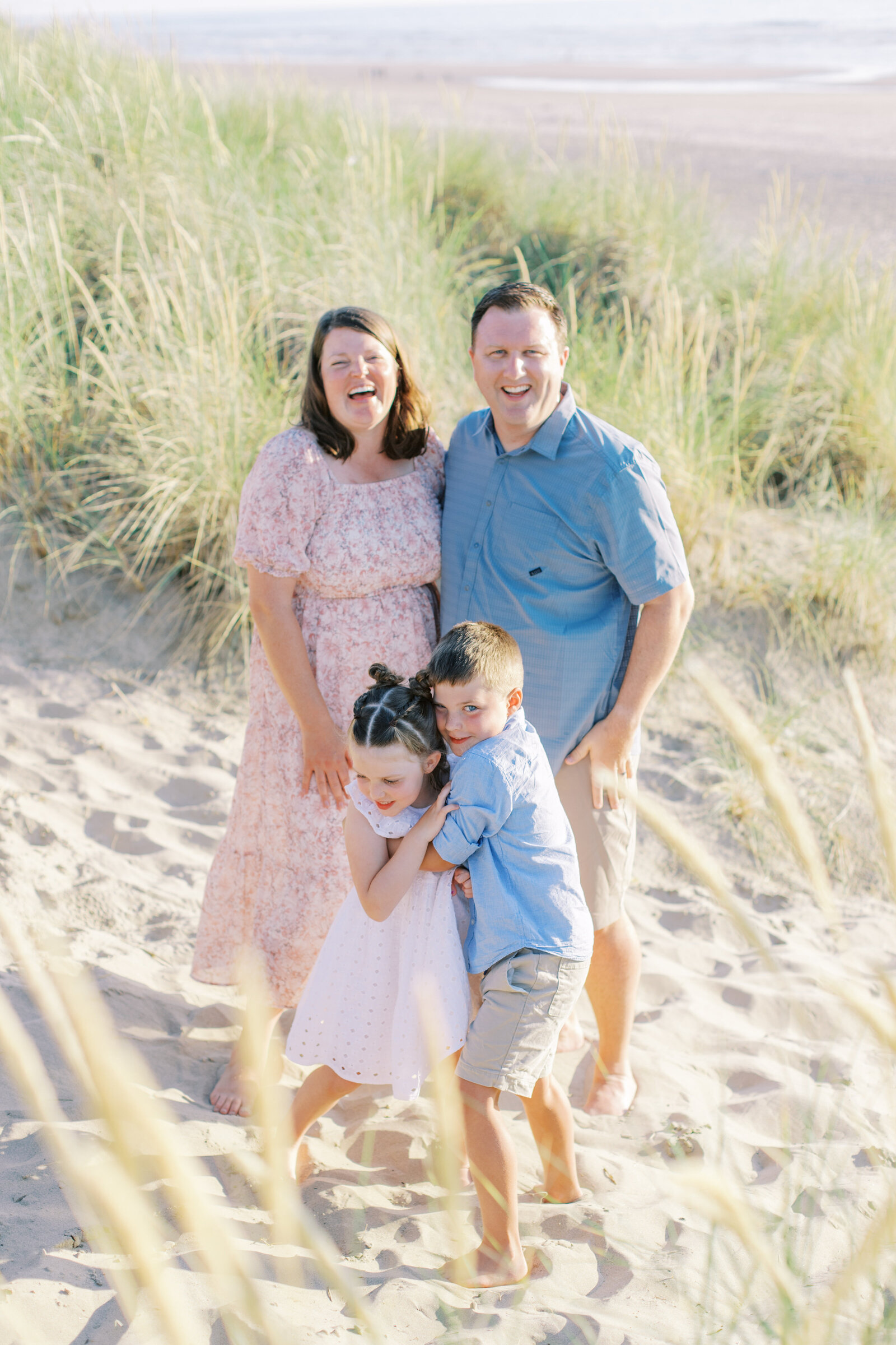 family smiling and hugging by family photographers spokane