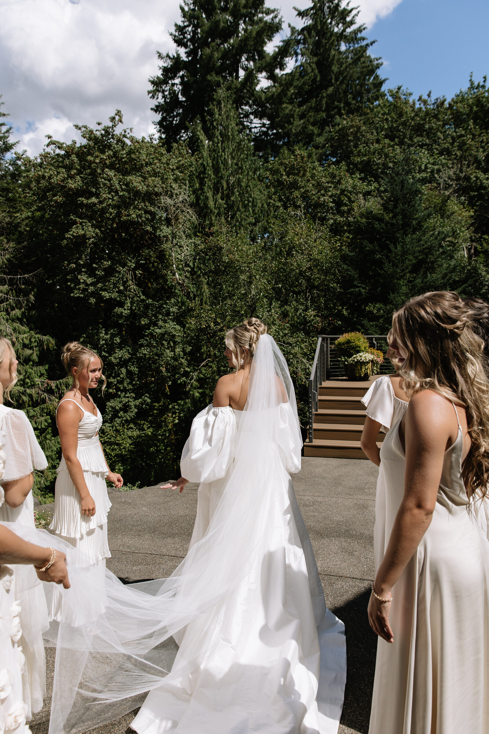 Bridesmaids fix bride's train while getting ready for elopement ceremony in Washington