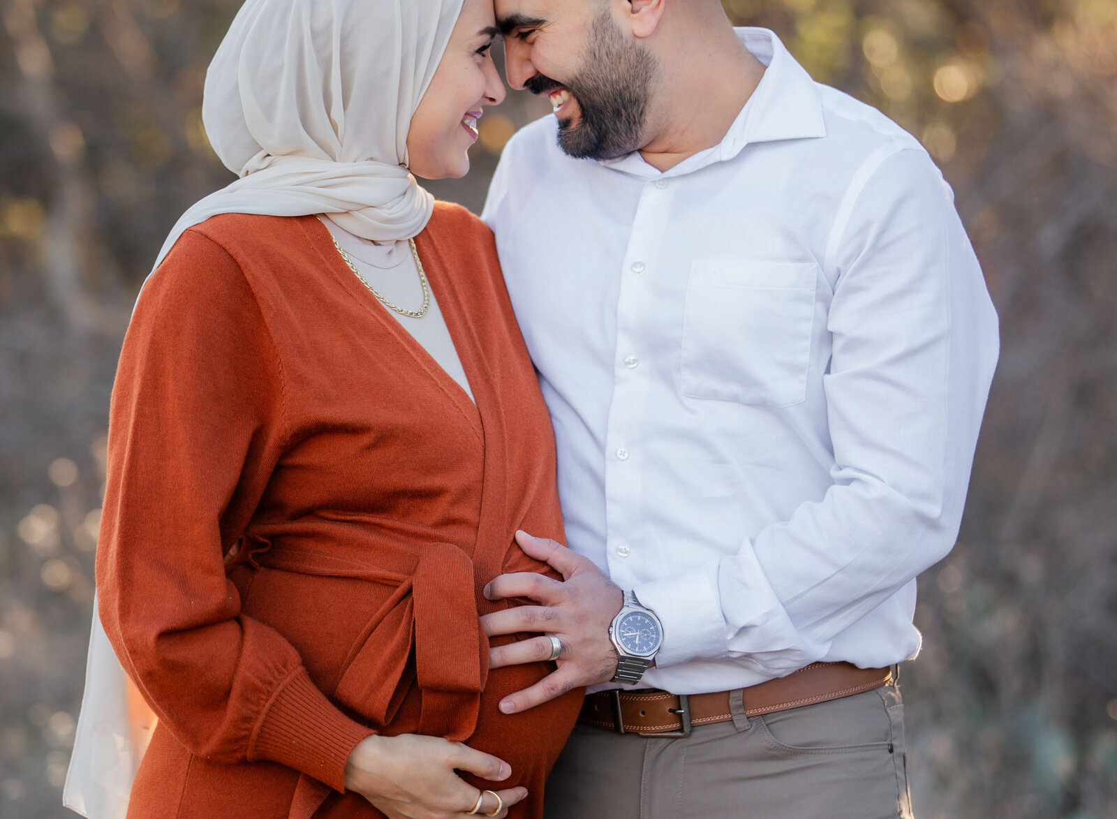 couple snuggling while pregnant