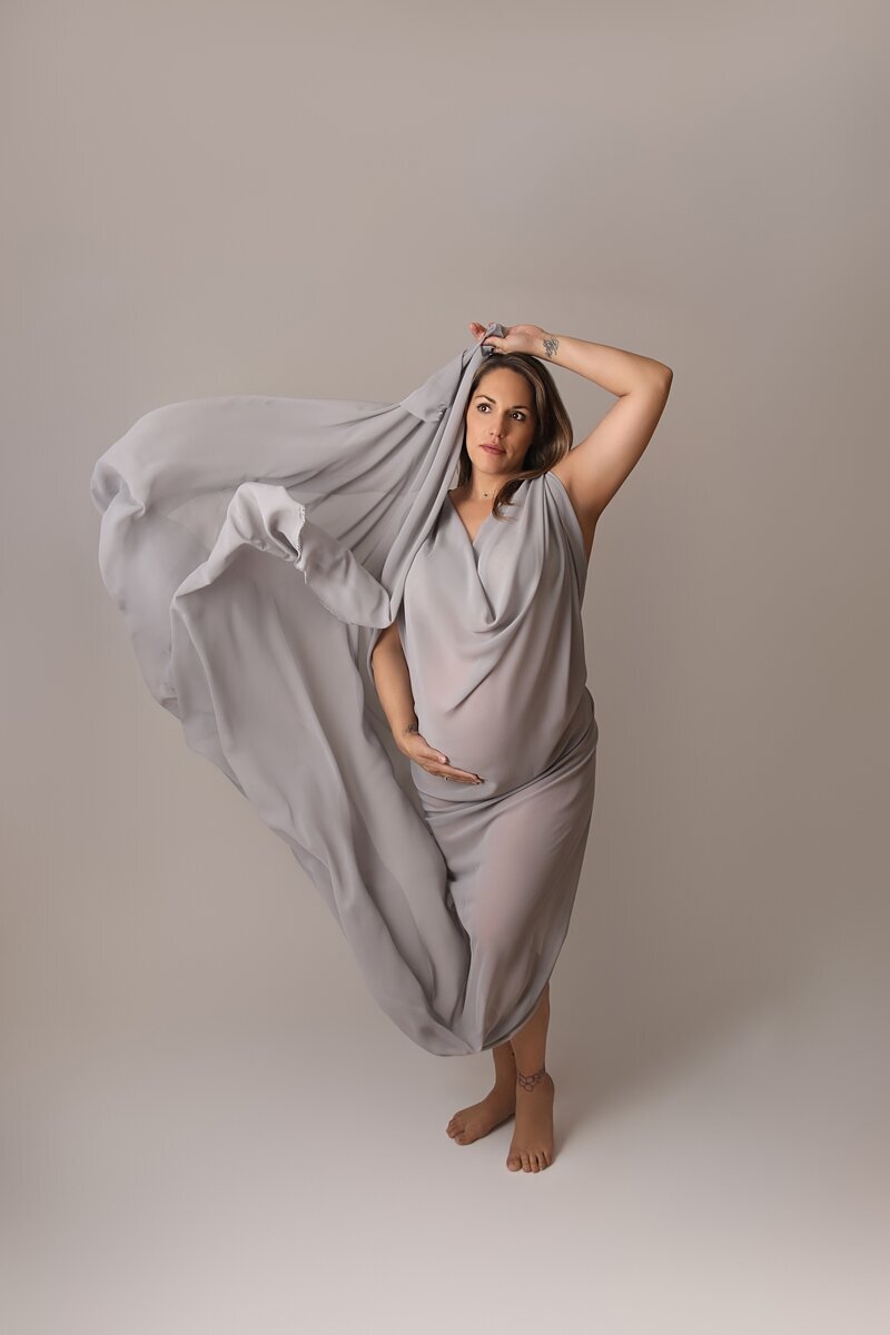 maternity session with grey fabric