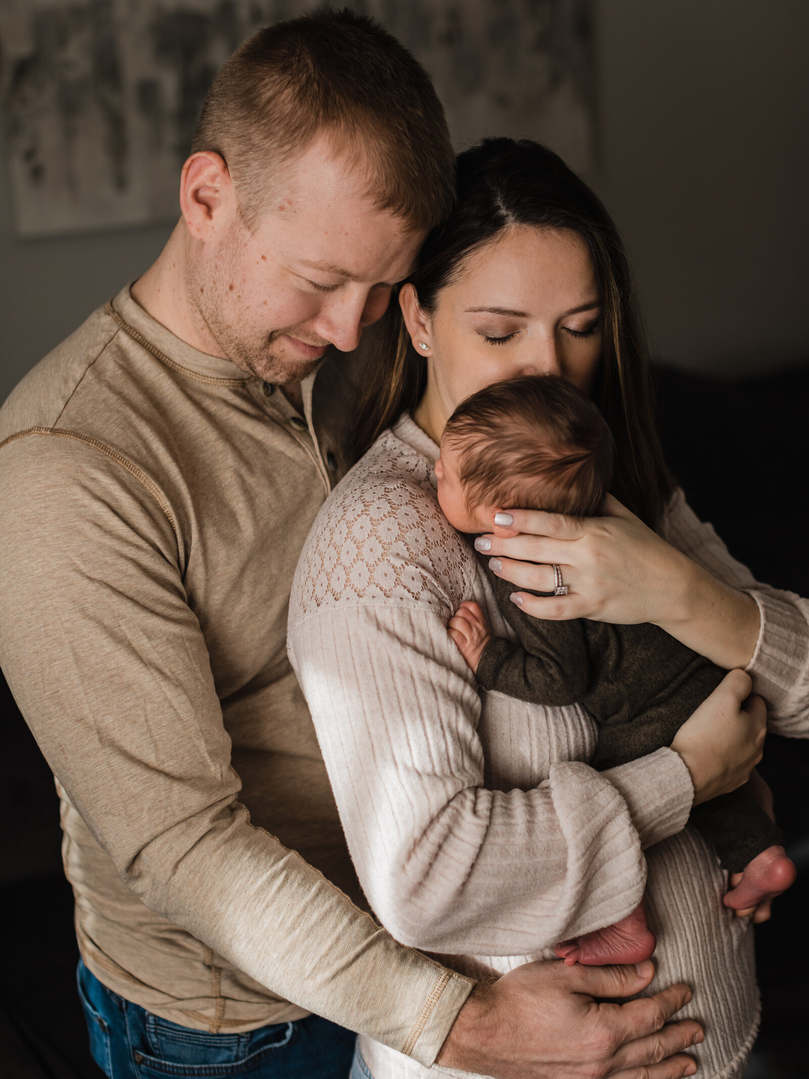 mom and dad holding newborn baby boy for in home lifestyle session