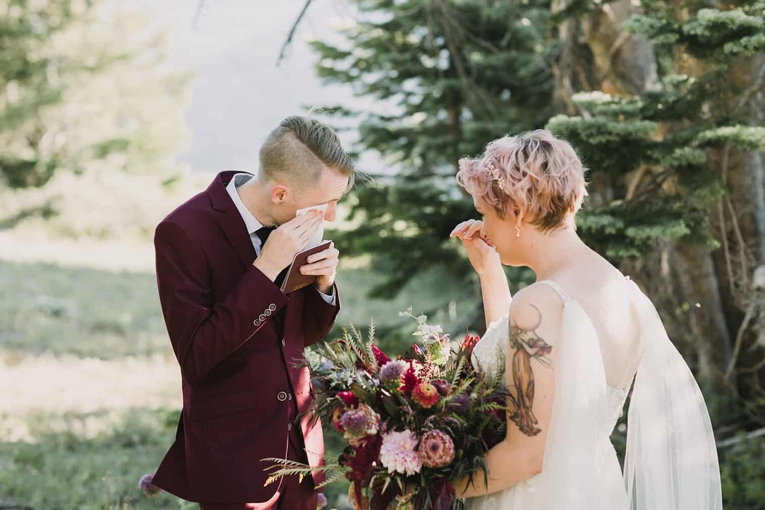 A bride and groom cry during their vows while in the shade of a pine tree while on their mammoth lakes wedding day. 