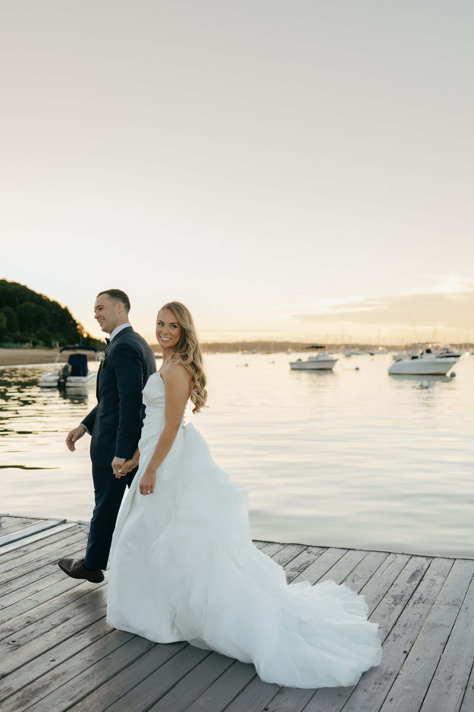 Bride and groom walking down the dock in Suffolk | Emma LeeAnn Photography