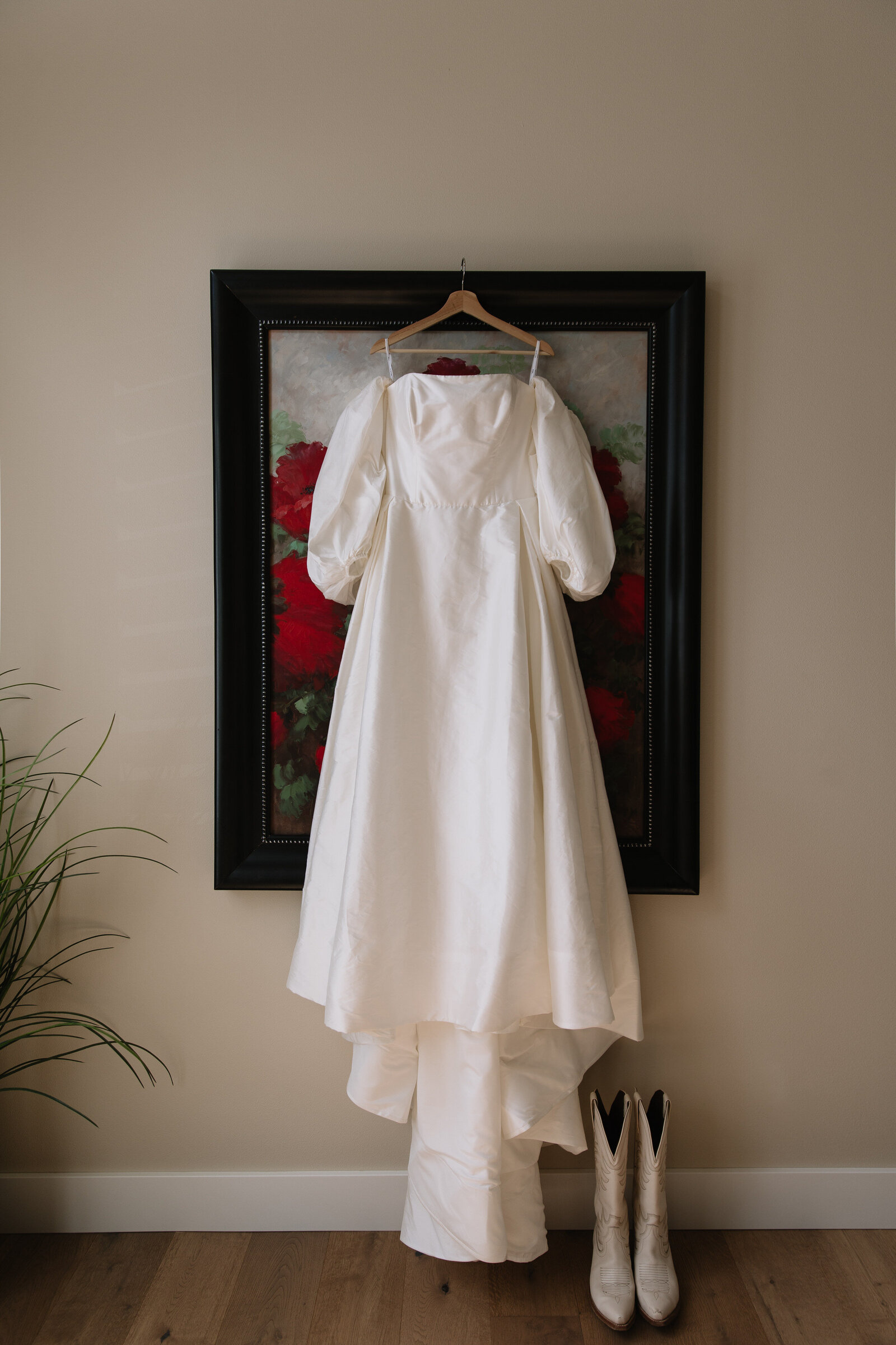 Modern wedding dress hanging from painting in Washington bridal suite