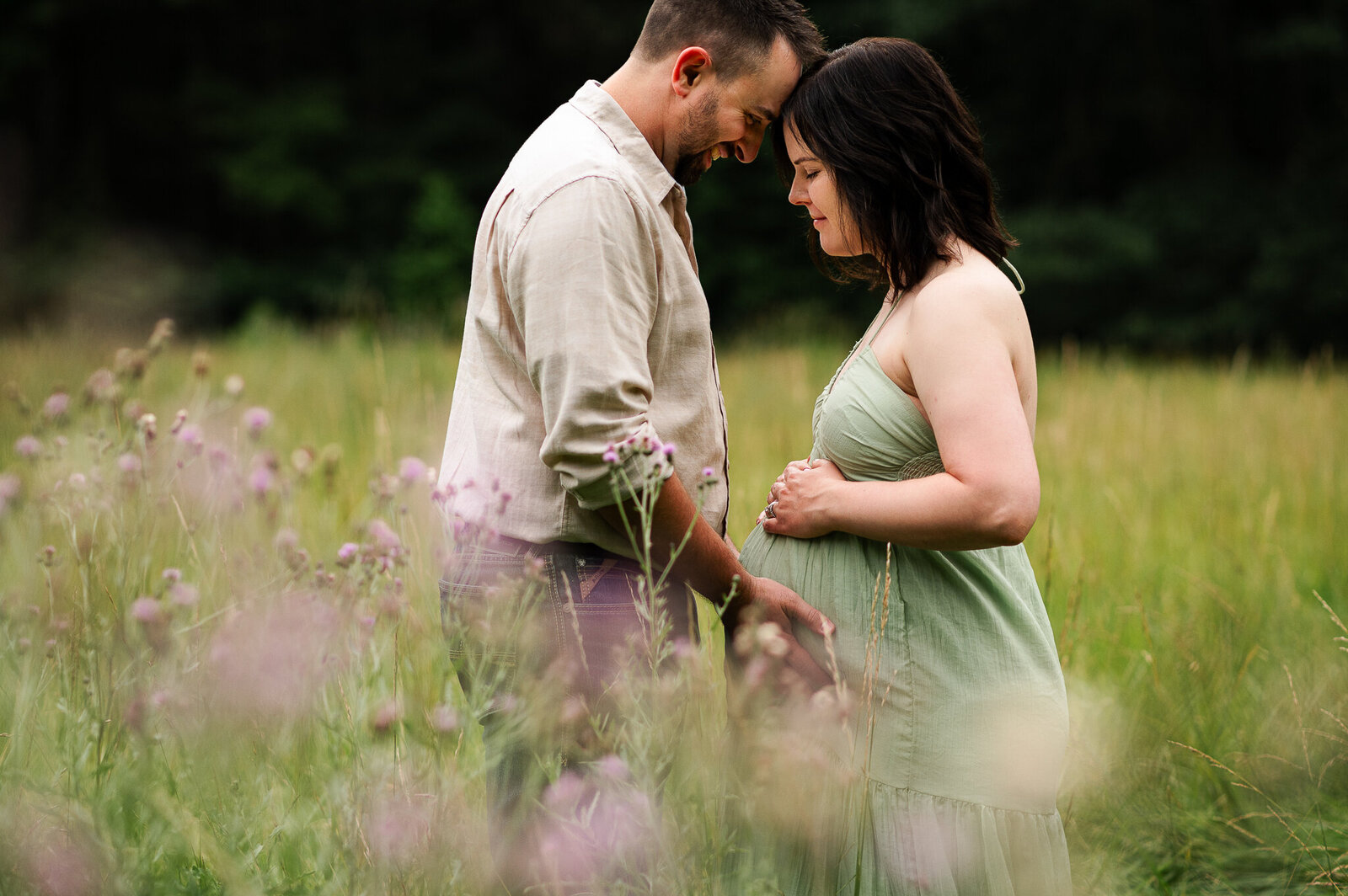 Couple standing flower field near toledo ohio maternity session