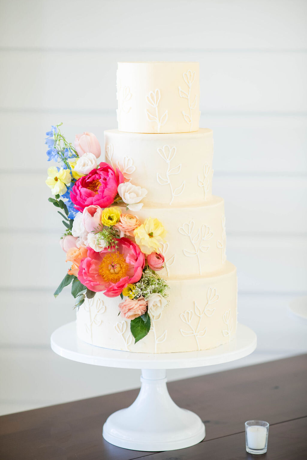 white wedding cake with bright florals