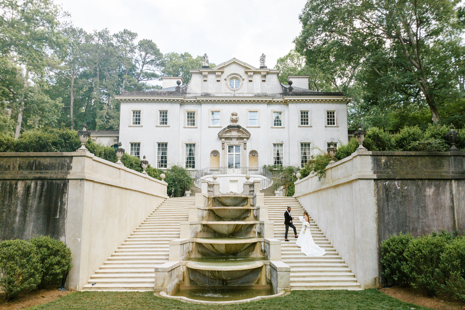 drone picture at the swan house atlanta history center with bride and groom at the steps holding hands