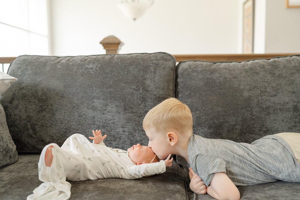 big brother kissing baby sister taken by TBP, a Fairfax County, VA newborn photographer