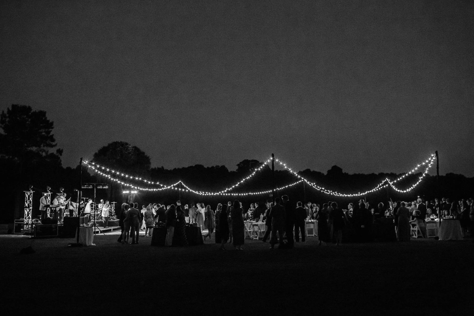 Guests dance at reception under oak tree, Oakland Plantation, Mt Pleasant, South Carolina