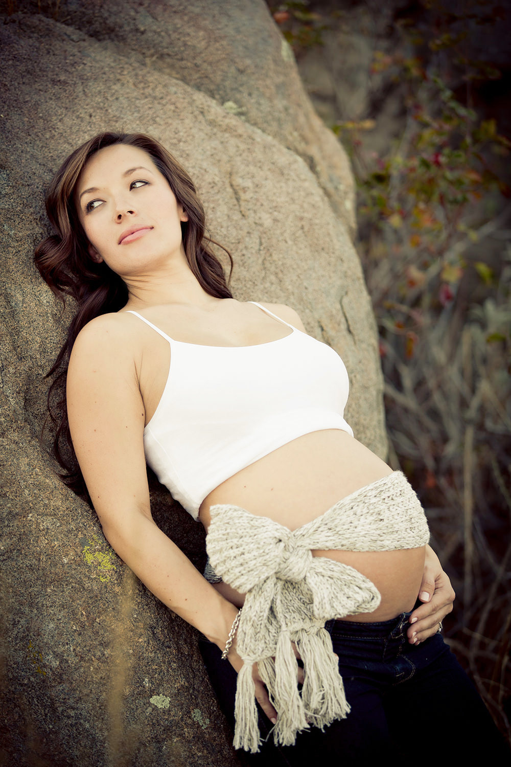 Soon to be Mom posing on a large boulder in San Diego.