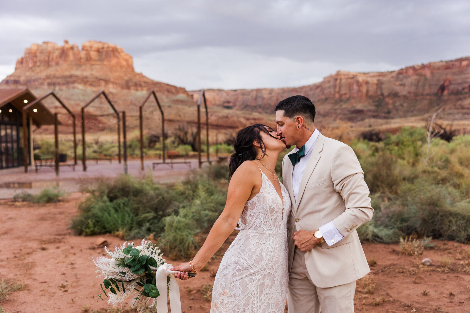 Bride reaches in and kisses groom on their wedding day in Utah