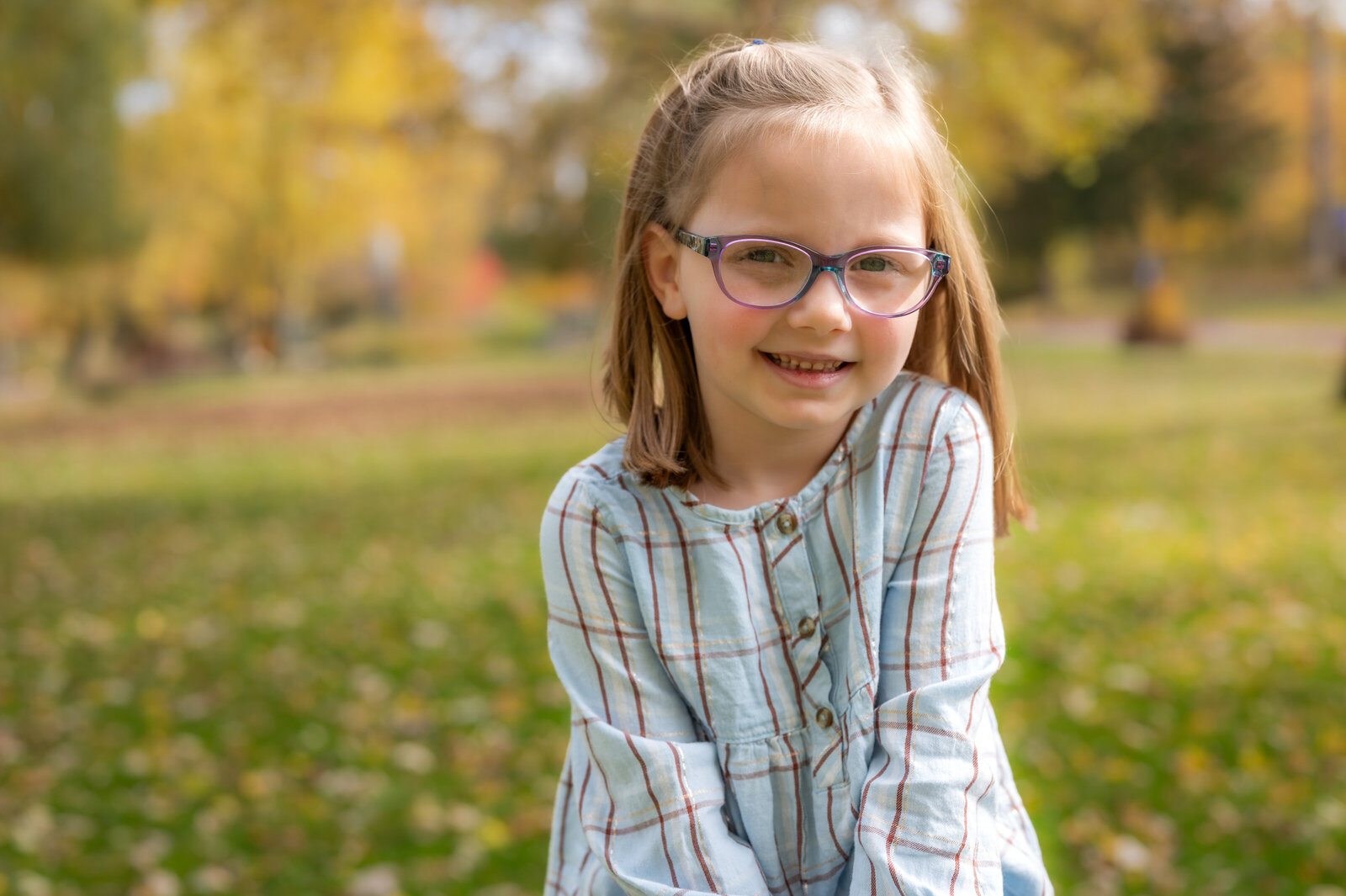 young girl sitting outside for school picture