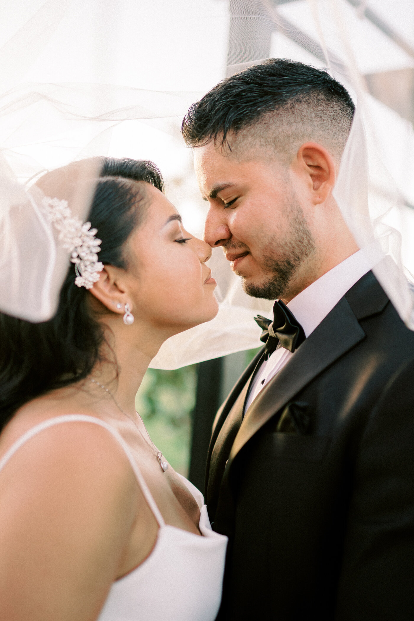 Bride and Groom embrace under the bridal veil during sunset at The Dalmore Fossil Creek