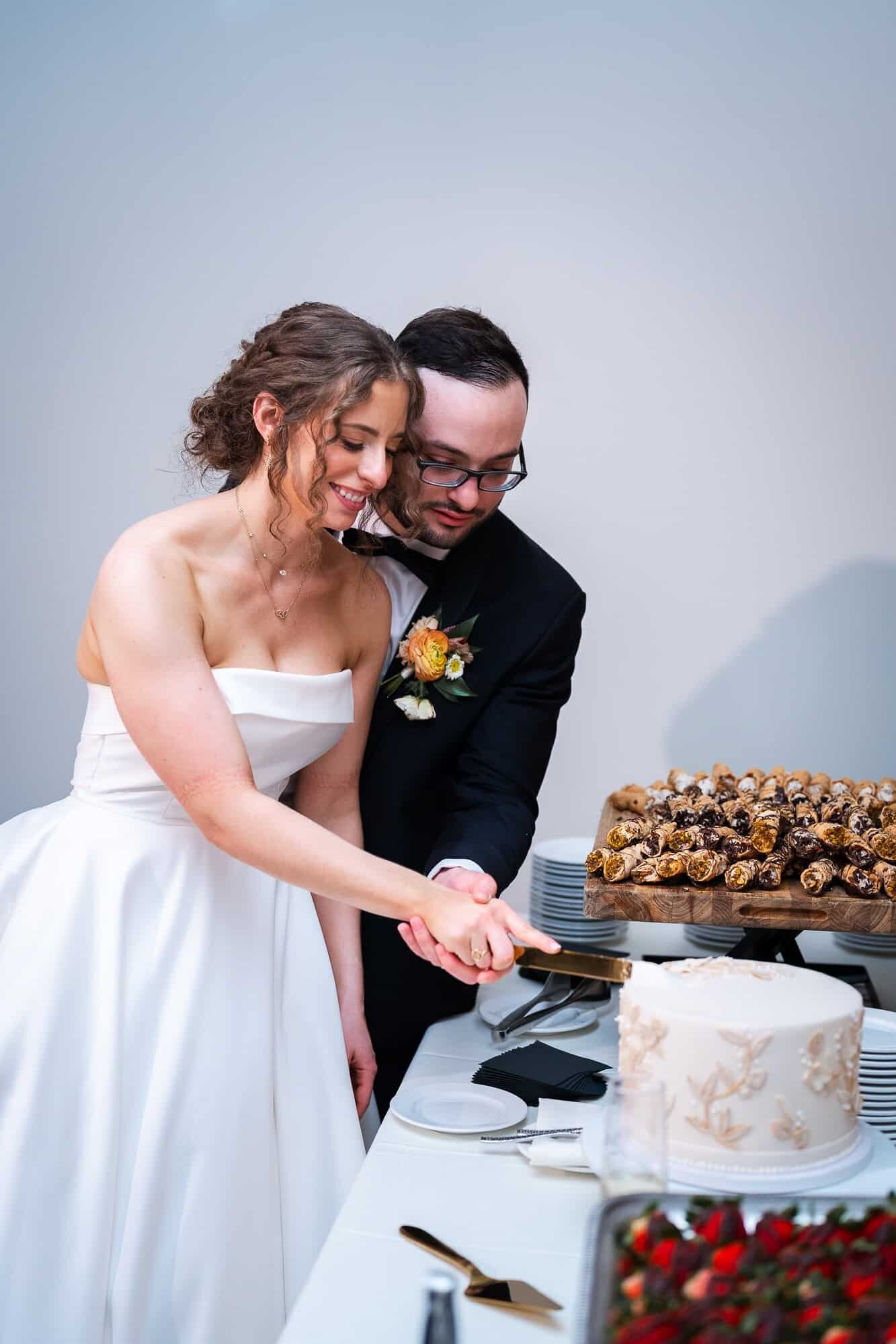 bride and groom cutting the cake at jewish wedding Casa Monica Wedding venue in St Augustine