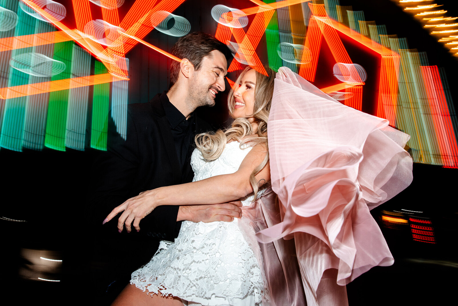 This couple posed in front of Neon signs for their Downtown Las Vegas engagement session