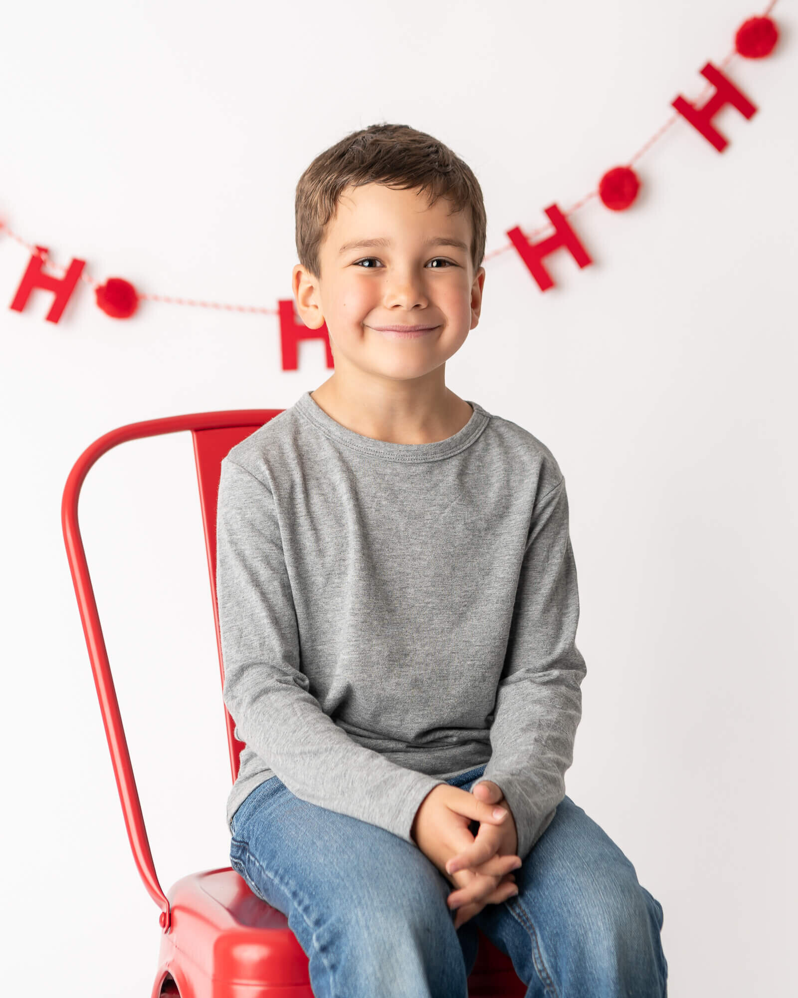 Christmas Card Picture of boy on red chair