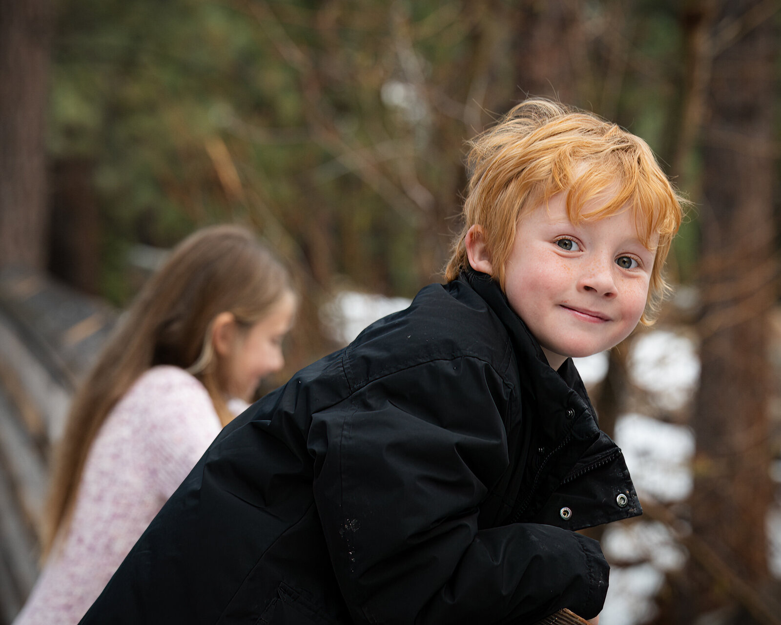 red hair boy smiling from bridge in galena