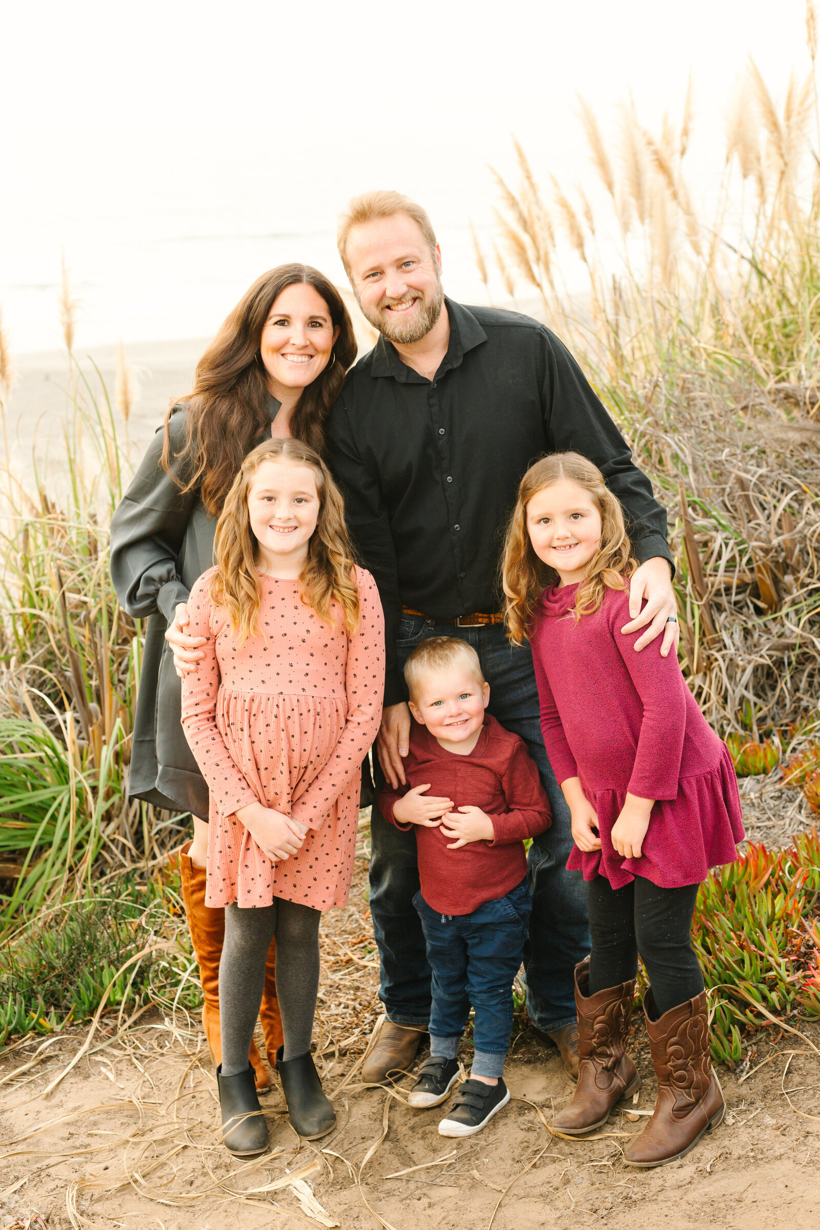 A family poses for photos along the beach in Santa Cruz, Ca.