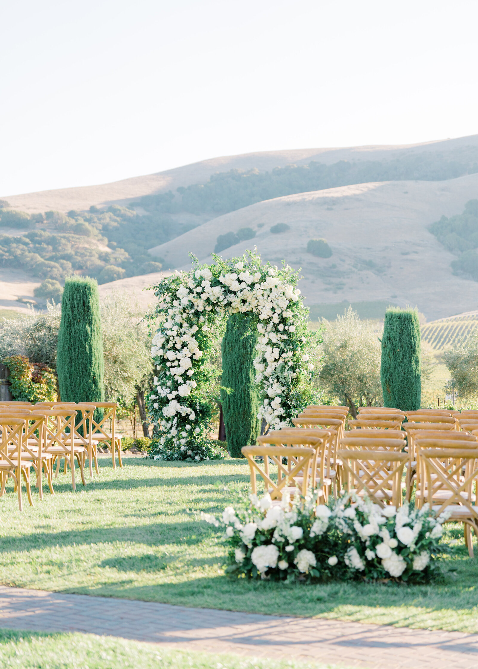 outdoor wedding venue and arbor with white roses