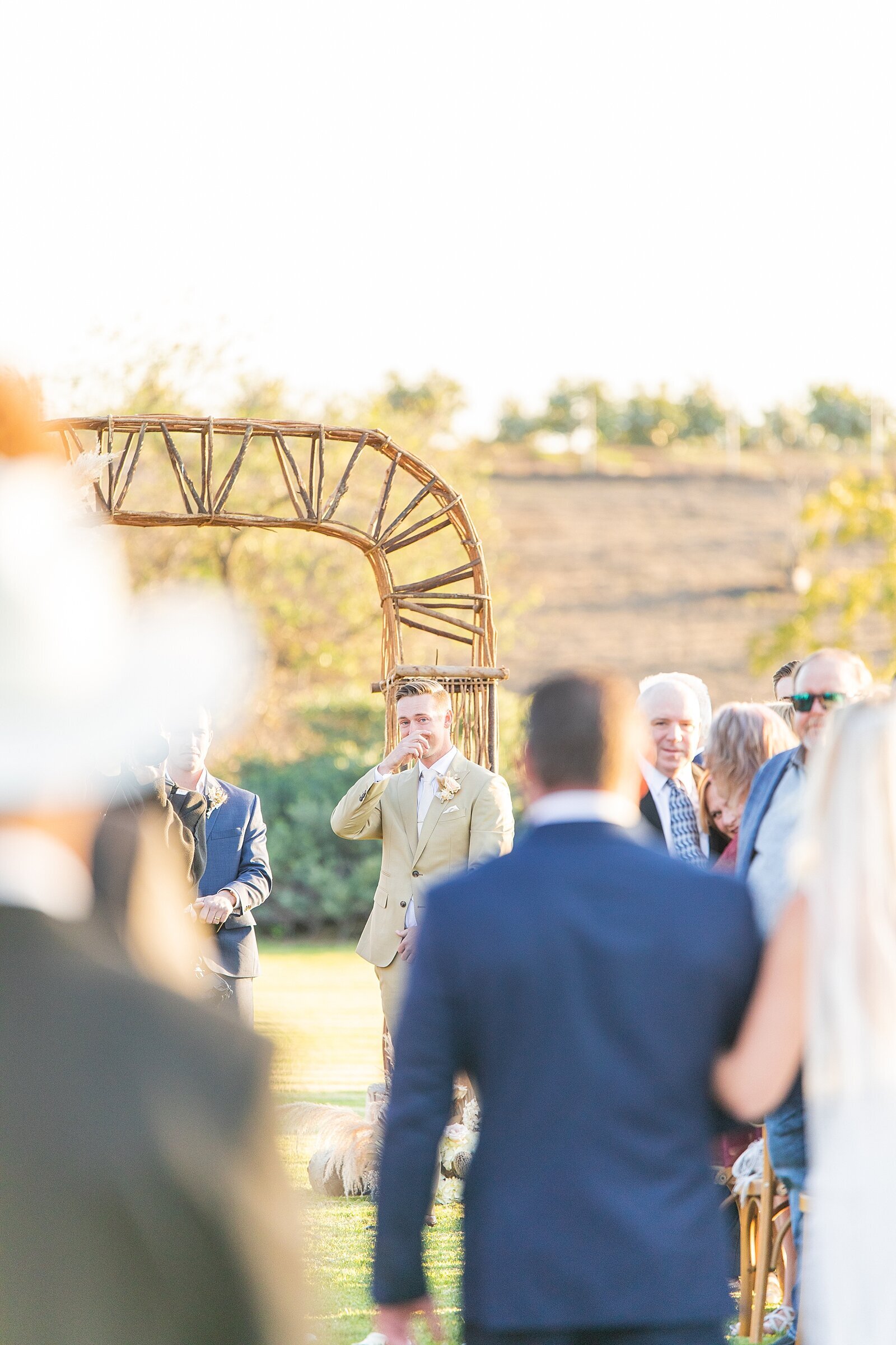 Groom crying as bride walks down the aisle at Ethreal Gardens wedding venue in Escondido.