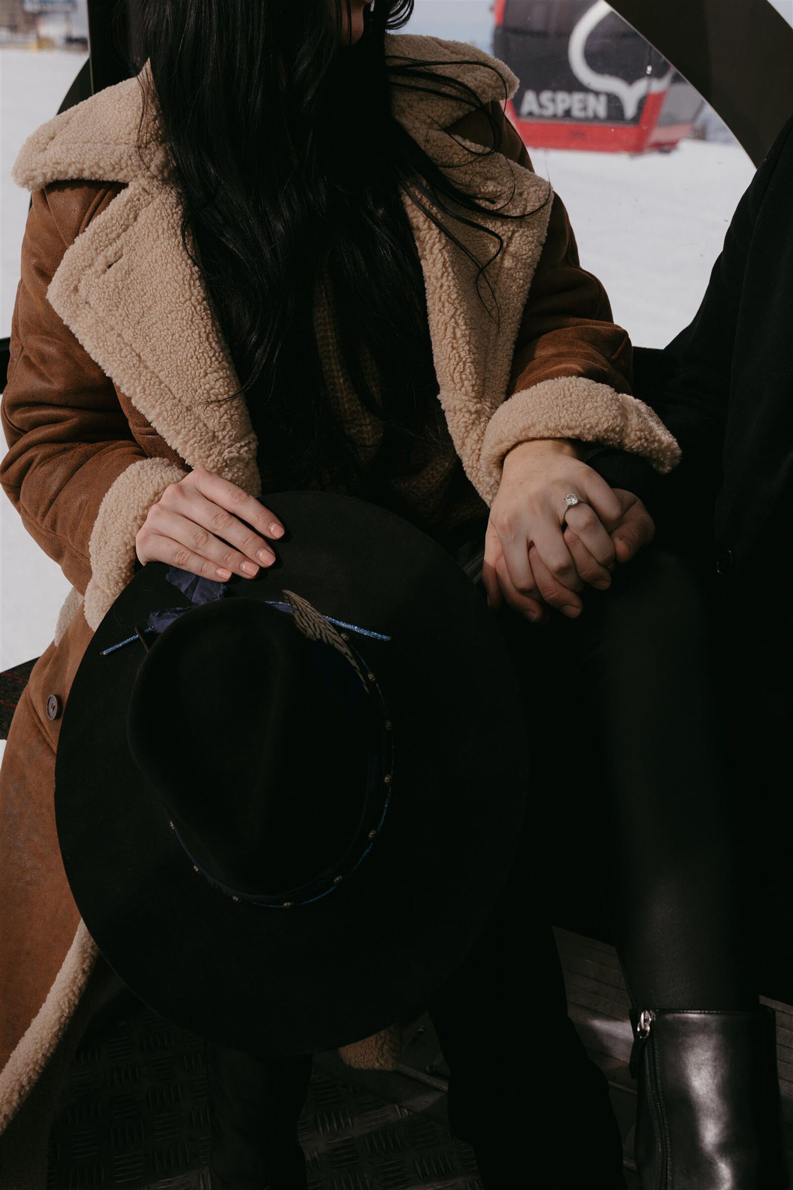 Couple riding gondola during Aspen winter engagement session