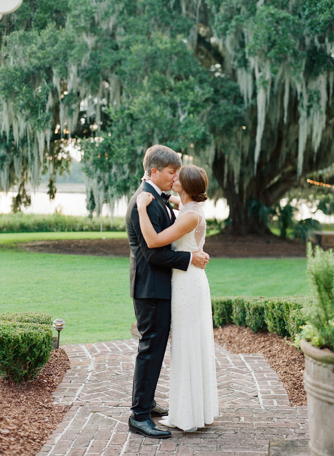 Bride and Groom Kissing on Walkway at Brays Island