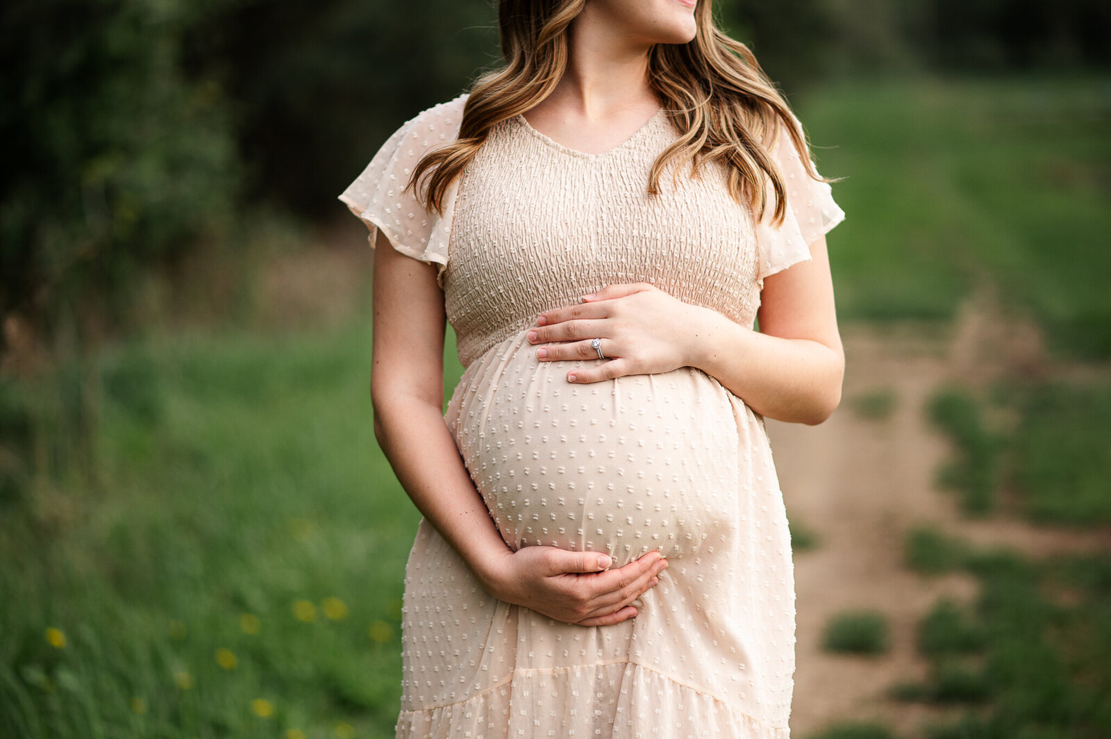 Mom holding belly outdoor session