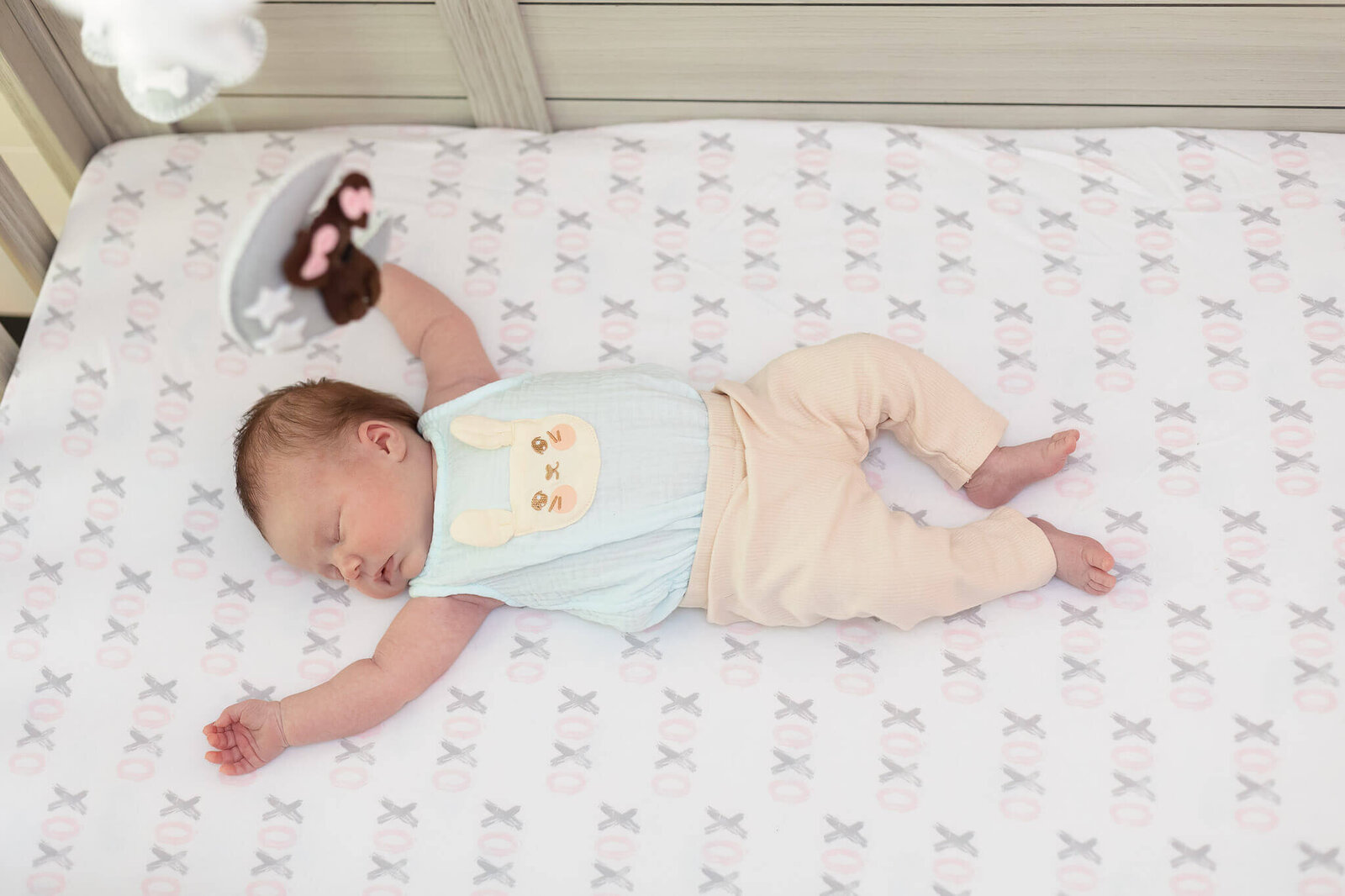 A newborn girl laying in her crib.
