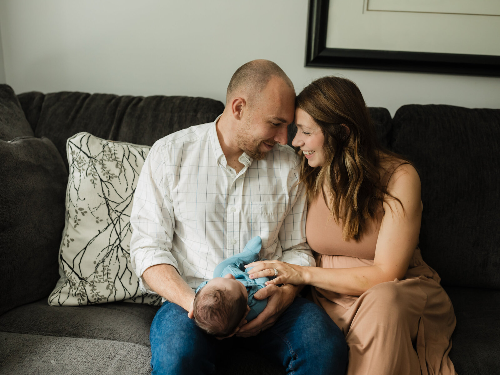 mom and dad holding newborn baby boy for in home lifestyle session 