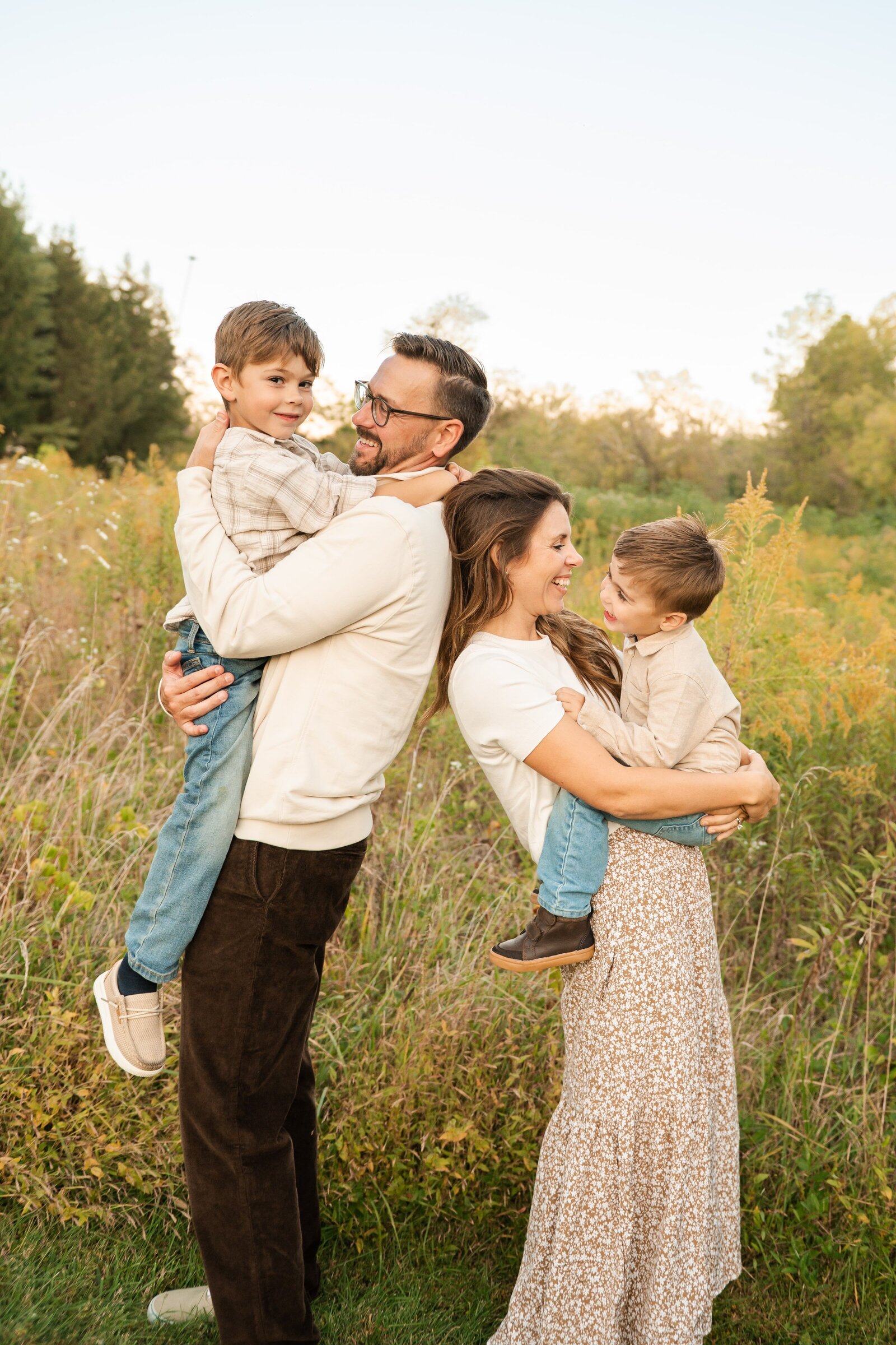 Family laughing together during an outdoor session captured by a Baltimore family photographer.