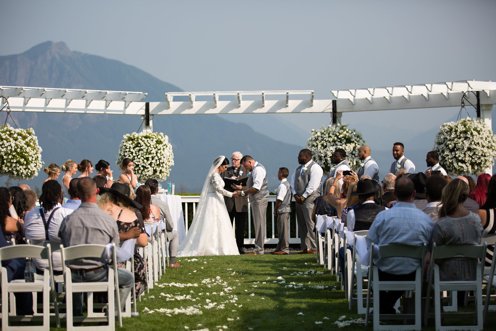 Wedding ceremony at the Club at Snoqualmie Ridge. Seattle bride and groom with large wedding party