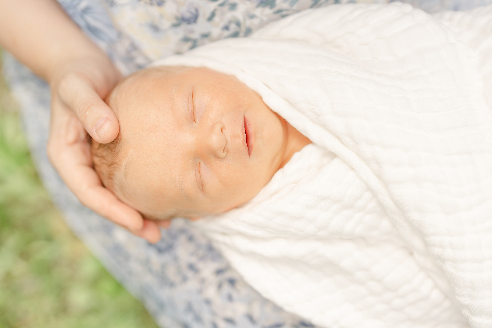 close up of baby's face while held by mom during Leesburg, VA newborn photography