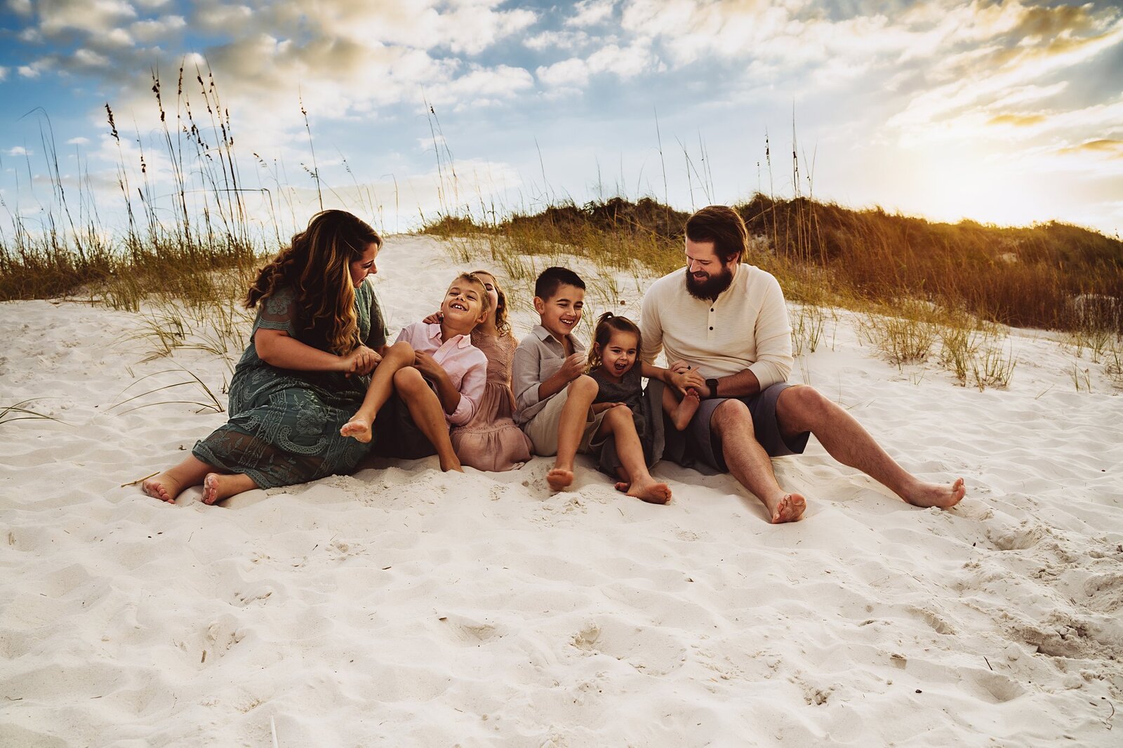 family sitting on sand dune clearwater beach