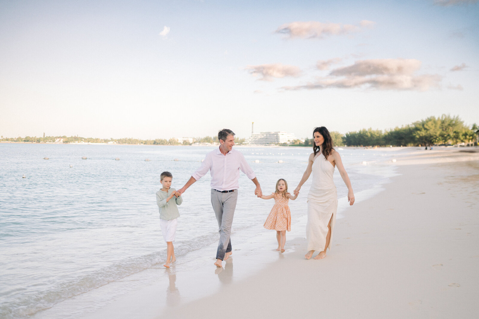 Family with small children holding hands on the beach at Grand Hyatt Baha Mar