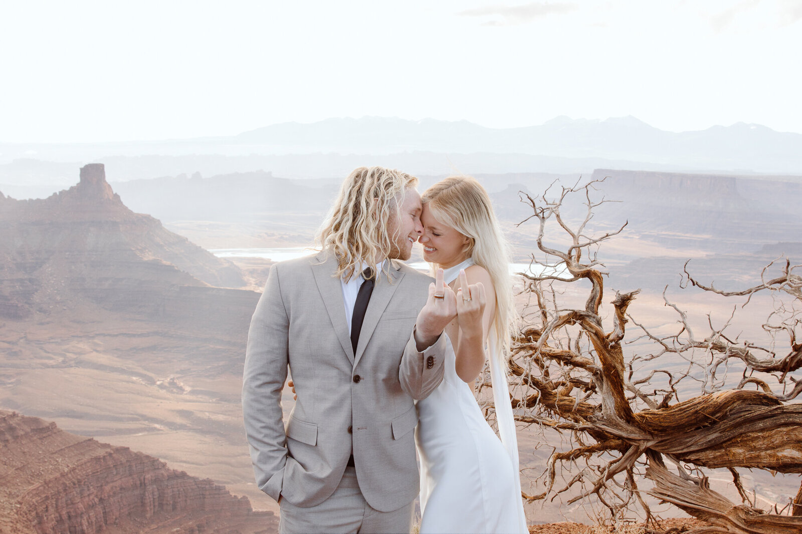 Couple showing their wedding rings with a view 