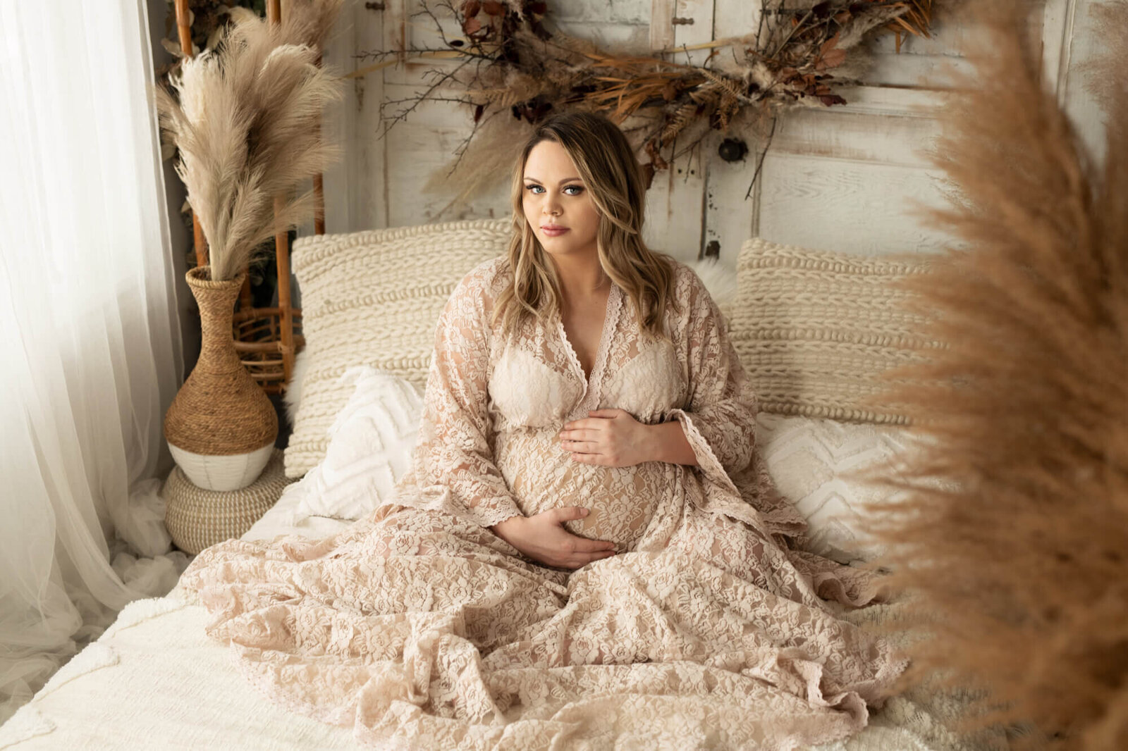 Pregnant mother in white lace boho gown