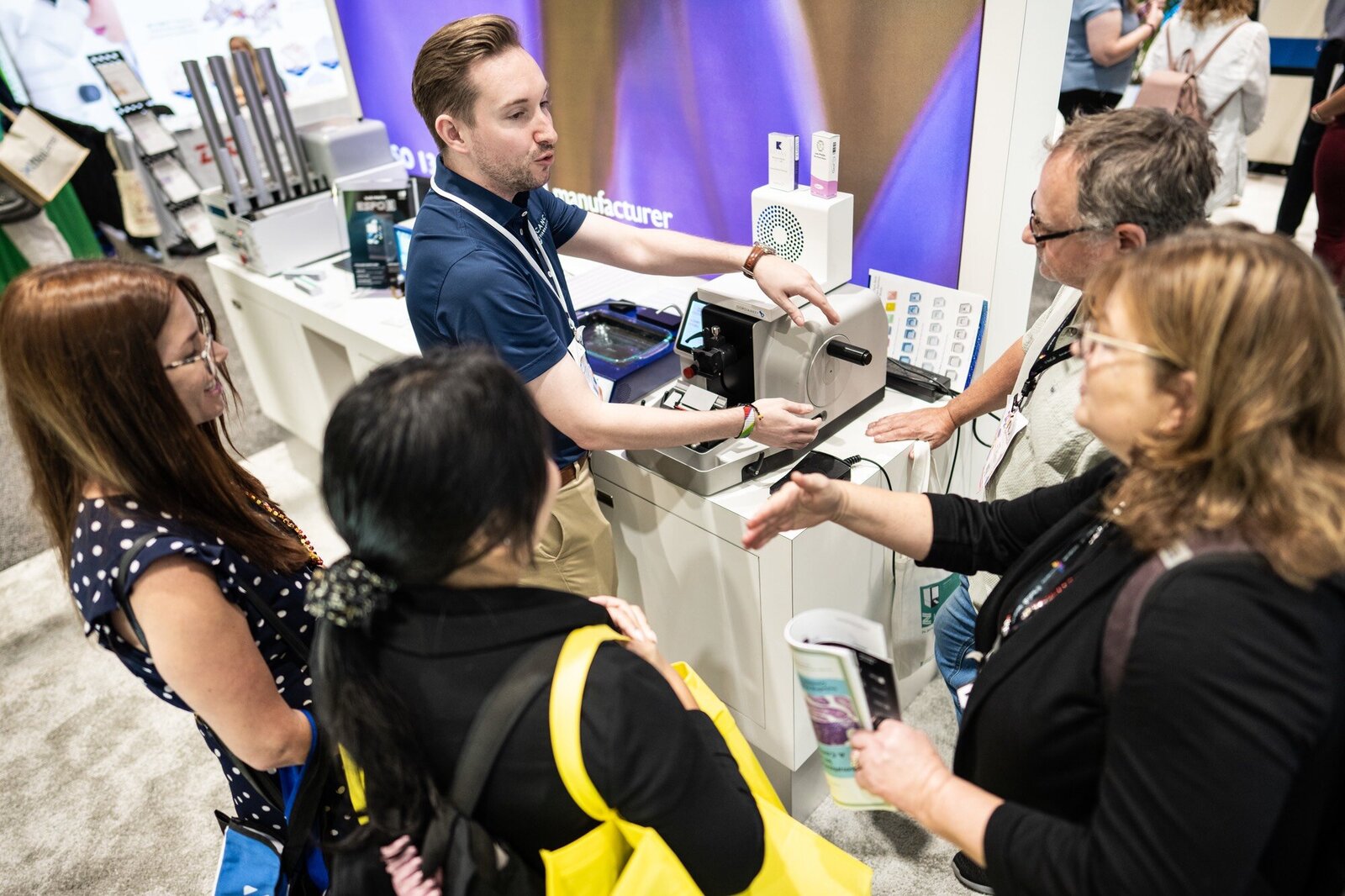 Company representative demonstrating product to attendees of trade show in New Orleans