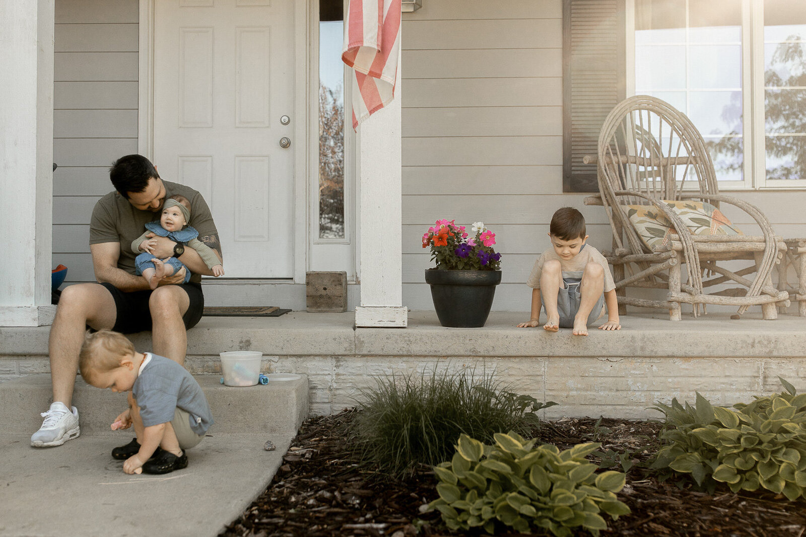 Waukee Iowa family sitting on front porch and playing together