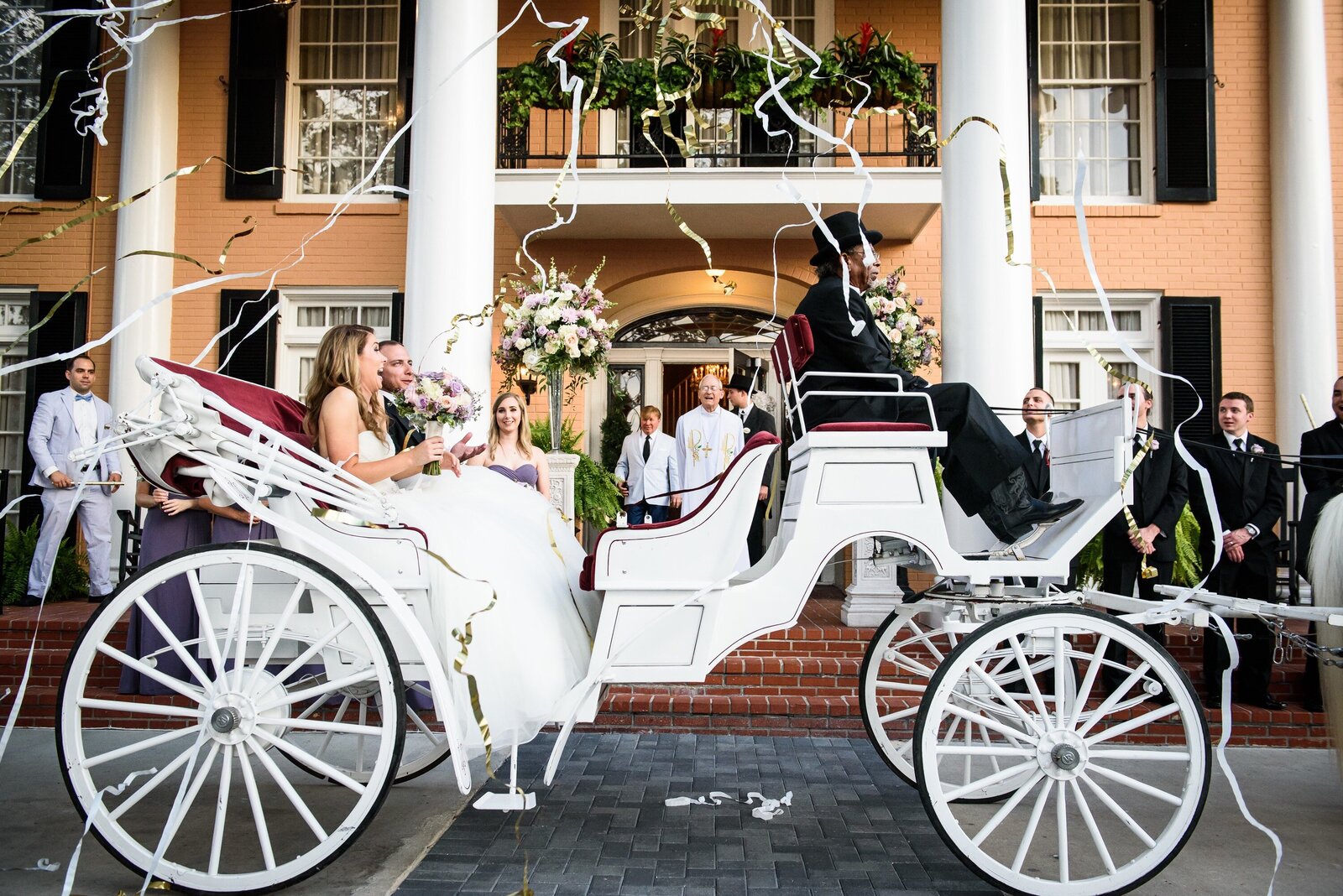 Bride and groom on carriage at Southern Oaks wedding