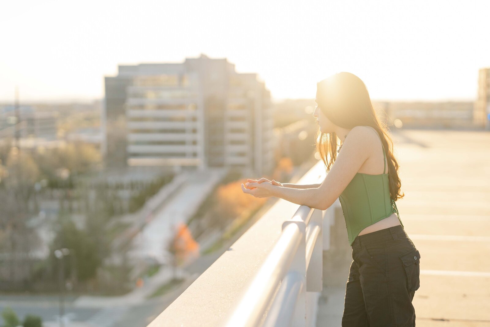girl looking over from the parking garage during Reston, Virginia senior photography