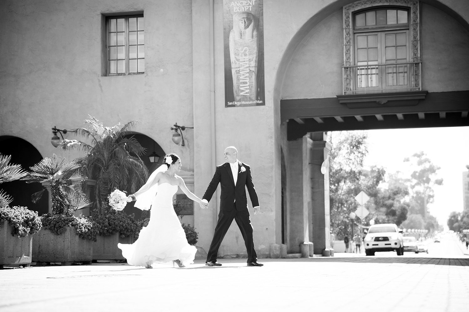 bride and groom walking in balboa park for a prado wedding