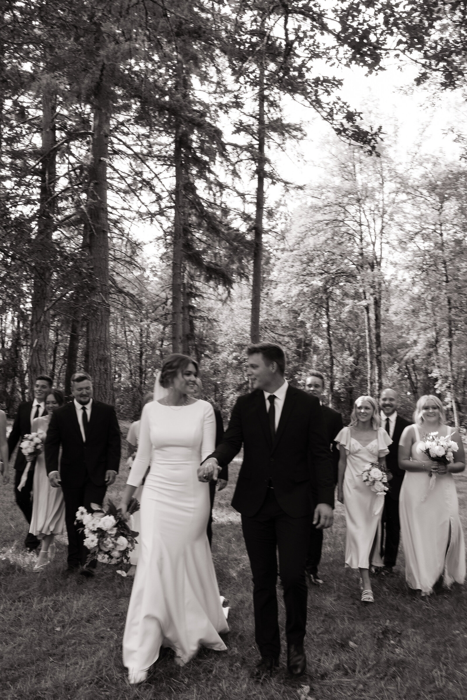 Bridal party walking through foggy Washington mountain meadow